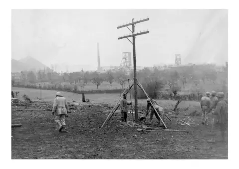 40th battalion linemen setting up poles